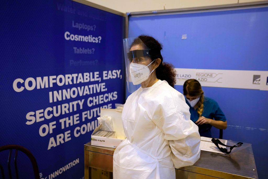 Medical staff wait for passengers on a flight from Guangzhou to Rome